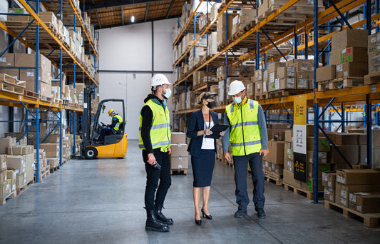 Group of warehouse workers and a manager organizing packages at a warehouse facility for WarehouseAddress.com