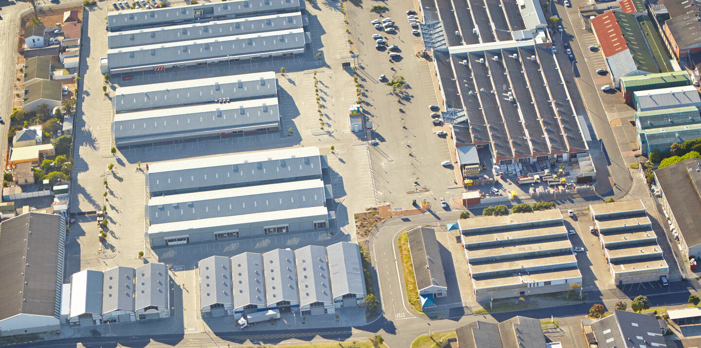 Aerial view of a large warehouse complex with multiple storage buildings, loading areas, and surrounding streets.