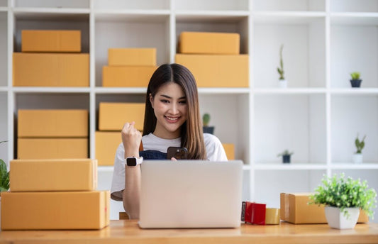 Small business owner browsing WarehouseAddress.com on laptop to find a real warehouse address for their ecommerce business.
