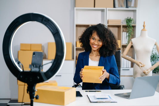 Smiling woman packing boxes for small business shipping