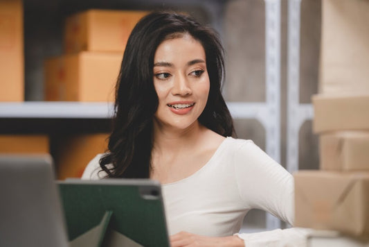 Woman smiling confidently while working in a virtual warehouse environment.