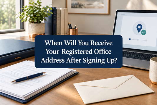 Company registration papers, a formal business envelope and a laptop on an organised office desk.