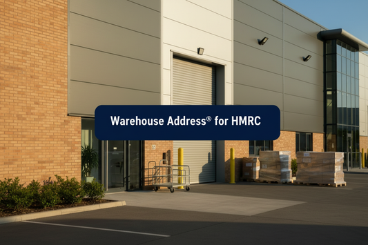 Modern UK warehouse loading bay with roller shutter, glass reception, pallets and parcel trolley, with a banner reading “Warehouse Address® for HMRC”